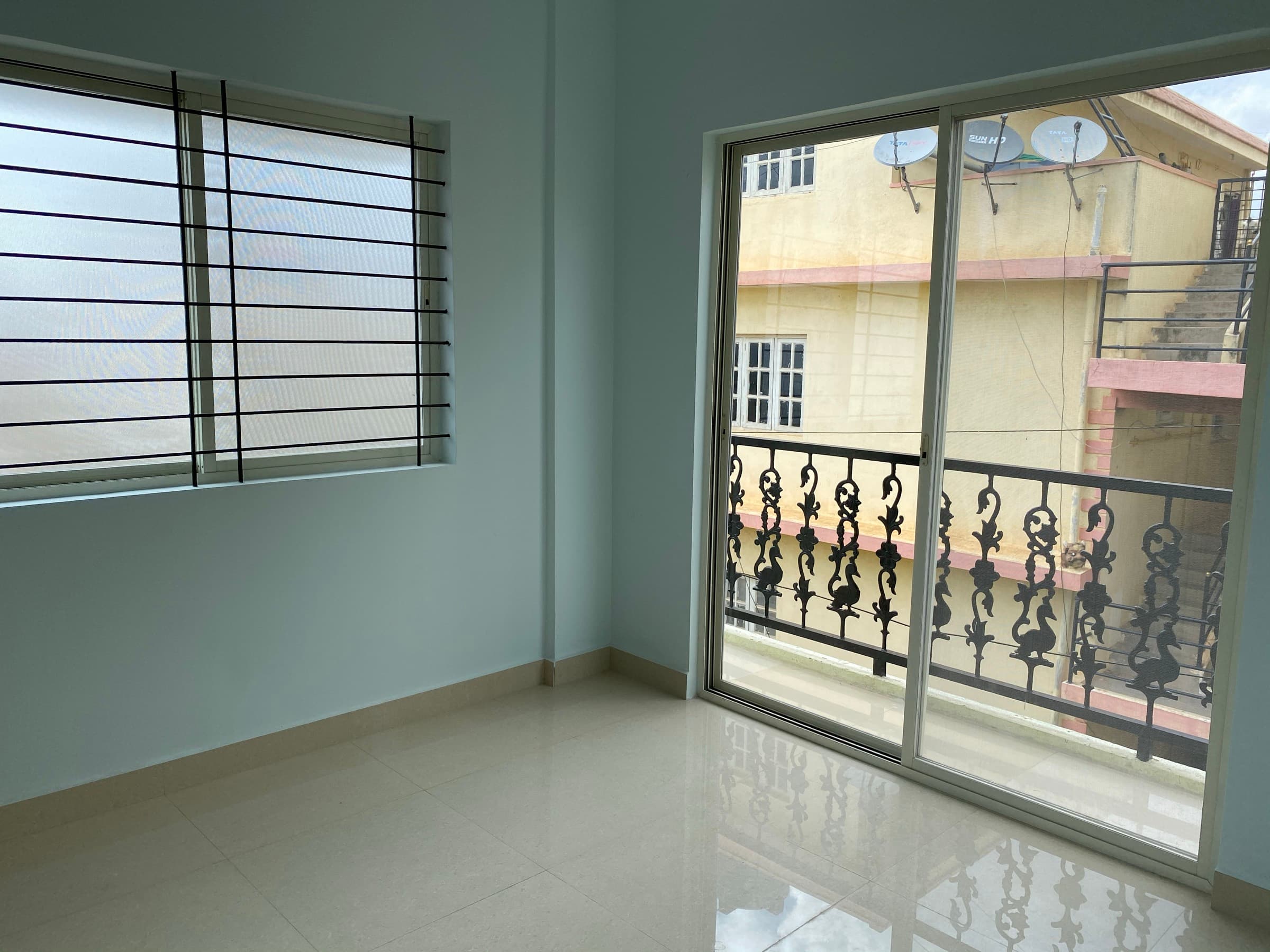 Geeta Ram Residency — bedroom window balcony door